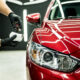 car service worker applying nano coating car detail 80x80